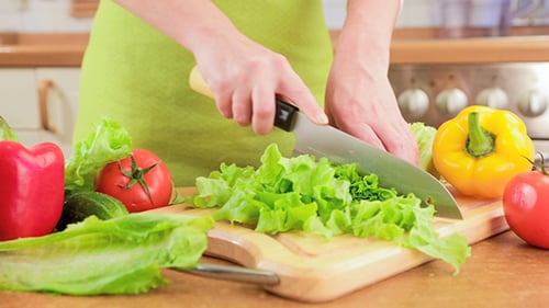 Chopping Fresh Vegetables in a Kitchen