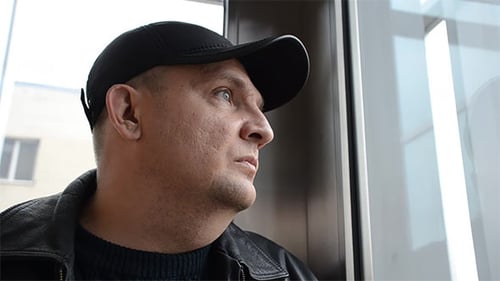 Man Riding in An Elevator