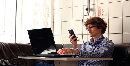Young Adult Working From Home on Laptop