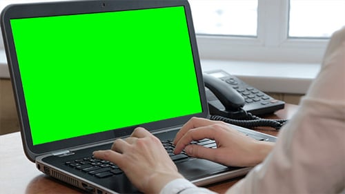 Woman Typing On Her Laptop with Green Screen
