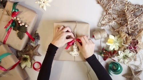 Wrapping Christmas Present with Paper and Ribbons