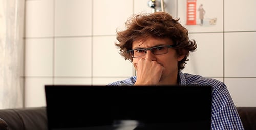 Young Adult Man Working From Home With Laptop
