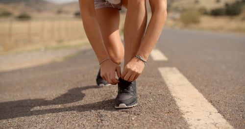 Sporty Girl Ties Her Shoe