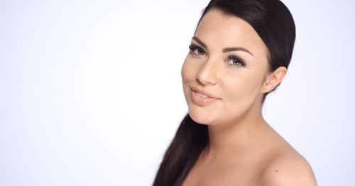 Beautiful Woman Posing in Studio Against White Background