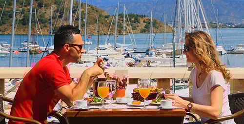 Couple Enjoying Waterfront Restaurant Meal on Sunny Day