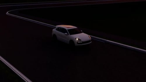 White Car Driving Past Wind Turbines At Sunset