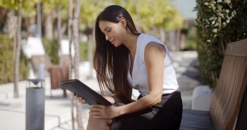 Businesswoman Using a Tablet In An Urban Park