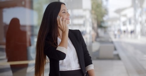 Businesswoman Chatting on Mobile Phone Outdoors