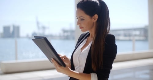 Confident Young Woman Using Tablet in City