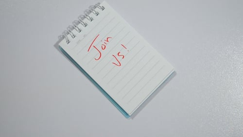 Hands Write Join Us on a Notebook