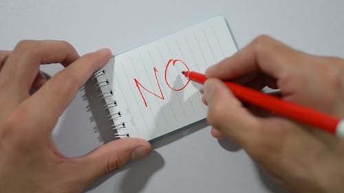 Writing No on Notepad in Red Ink