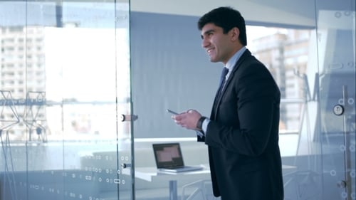 Well-Dressed Man Using Cellphone in Modern Office