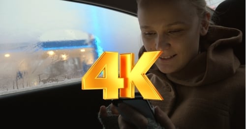 Woman Using Phone in Car on Winter Day