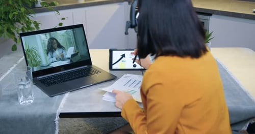 Office Manager Holding Video Chat with African American Woman and Consulting