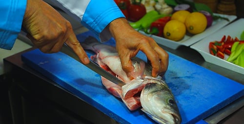 Chef Cutting Fish In Restaurant