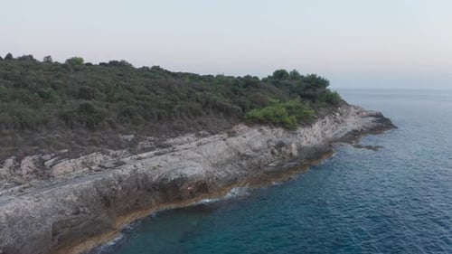 Aerial drone shot of a beautiful landscape near the sea. Camera flies slowly upwards revealing more