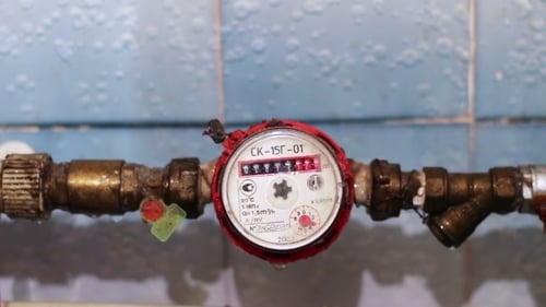 Water Meter on Metal Pipes in Home Interior