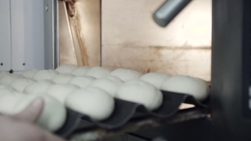 Placing Dough in Commercial Oven for Baking