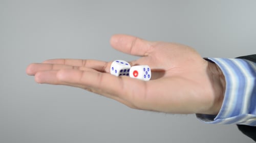 Hand Reveals Two Dice in Palm