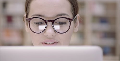Young Woman Works On Computer With Reflected Light