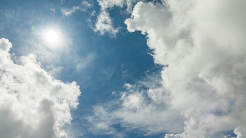 White Clouds Moving Across Blue Sky on Sunny Day