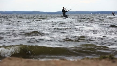 Kite Surfers On The Beach On a Windy Day