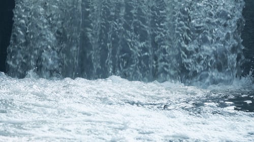 Refreshing Waterfall Cascading into Pool of Water
