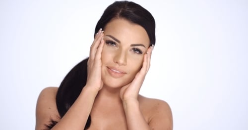 Beautiful Woman Posing and Touching Her Face