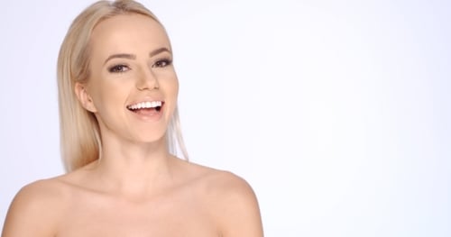 Attractive Blond Woman Smiling on White Background