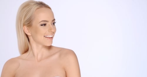 Blonde Woman Smiles in Close Up Portrait