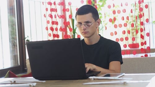 Student Using a Laptop in a Cafe