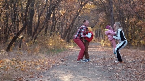 The Happy Family Walks In Autumn Park