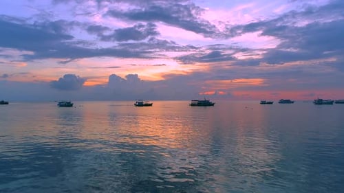 Sunset Over Tropical Ocean with Boats
