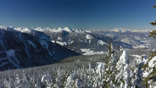 Aerial View High up in Winter Mountains With Much Snow on Sunny Day