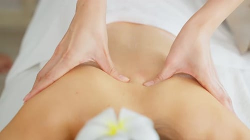 Close up of woman feeling happy and relax during back massage with oil.