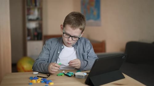 Boy Learning Construction with Digital Tablet at Home
