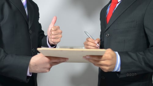 Businessmen Signing Contract at Meeting