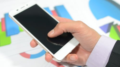 Hand Busy with Phone, Office Table and Documents