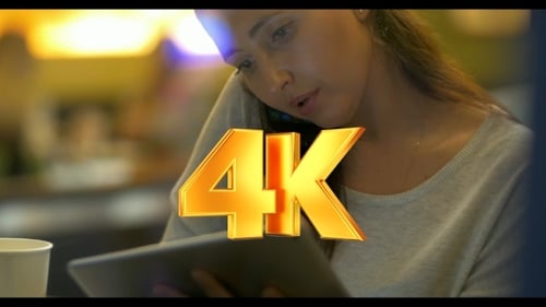 Woman Working on Tablet and Talking on Phone