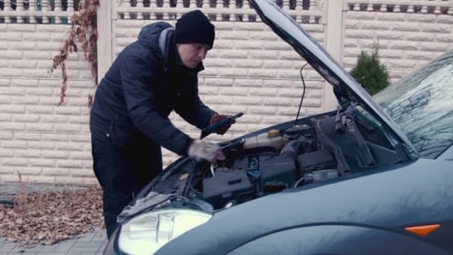 The Man Checks The Engine Using The Touchpad