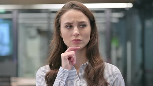 Woman Contemplates Options in an Office Setting