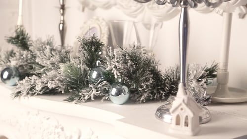 Holiday Mantel Decorated with Garland and Ornaments
