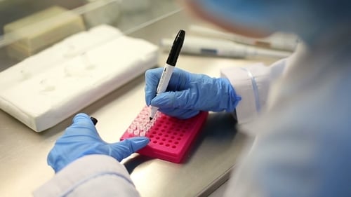 Scientist Marking Vials in a Lab