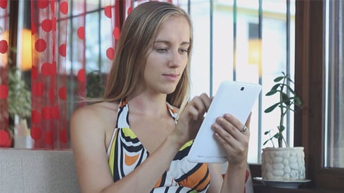 Woman Using Tablet Device Indoors