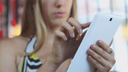 Woman Using Tablet Device in Urban Setting