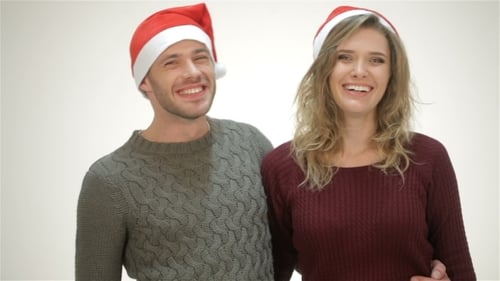 Happy Couple Wearing Santa Hats Smiling Together