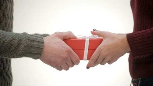 Gift Exchange Between Two People Indoors