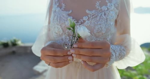Elegant Bride Holding Flower with Wedding Rings