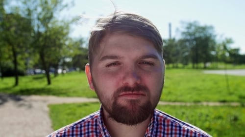 Woman Rumples Face To Smiling Man In Park