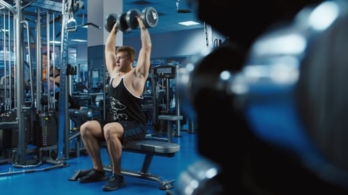 The Athlete Trains Biceps With Dumbbells. Shooting